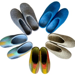 May include: A set of ten colorful wool slippers arranged in a circle. The slippers are in various shades of blue, gray, green, and yellow.
