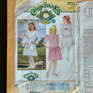May include: A sewing pattern for a girl's dress with a pink and white color scheme. The pattern is for Cabbage Patch Kids dolls and includes instructions for making a dress with a bodice, detachable sleeves, and a hip band. The pattern is size 10 and includes a size chart for sizes 7-14.