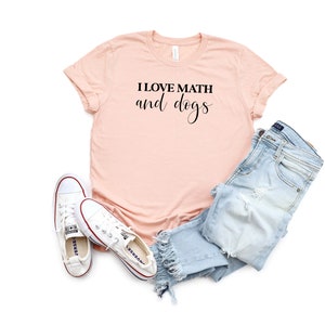 May include: A peach-colored t-shirt with the text "I love math and dogs" printed in black.