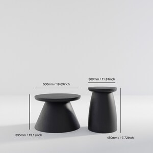 May include: Two black side tables with round tops and conical bases. The larger table measures 19.69 inches in diameter and 13.19 inches in height. The smaller table measures 11.81 inches in diameter and 17.72 inches in height.