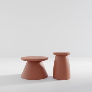 May include: Two terracotta-colored ceramic pedestal tables, one taller than the other, on a white background.