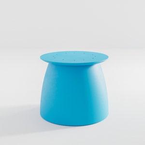 Pu&ograve; includere: Uno sgabello rotondo di colore azzurro chiaro con una base leggermente svasata. La parte superiore dello sgabello presenta una serie di piccoli fori.