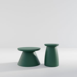 May include: Two green pedestal tables, one tall and one short, on a white background.