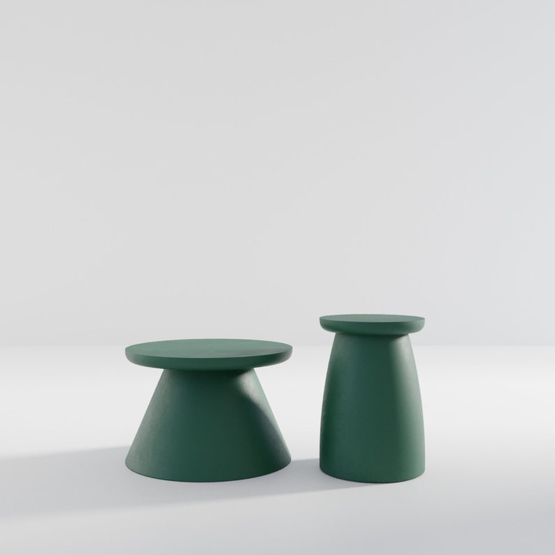 May include: Two green pedestal tables, one tall and one short, on a white background.