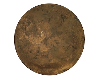 May include: A round, brown, textured object with a small, light yellow spot in the center.