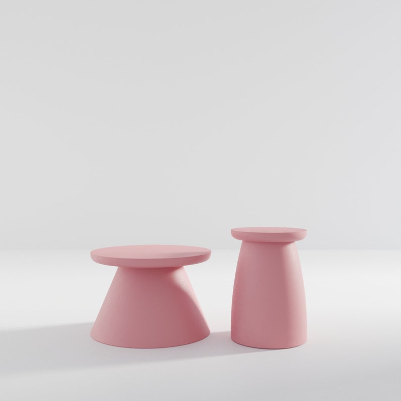 May include: Two pink pedestal stands, one tall and one short, on a white background.