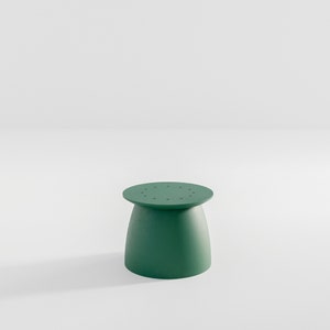 May include: A green, round stool with a slightly flared base and a top with small holes.