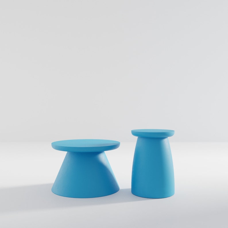 May include: Two blue pedestal stands, one tall and one short, on a white background. The stands are made of a smooth, solid material and have a rounded top.