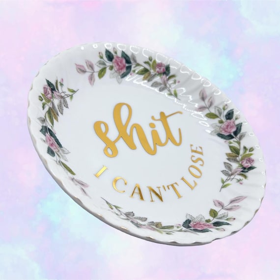 A sassy 'Shit I Can't Lose' label applied to a genuine piece of repurposed antique china — upcycled vintage with attitude.