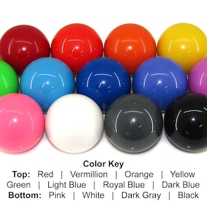 May include: A set of ten colorful balls arranged in a circle. The balls are red, vermillion, orange, yellow, green, light blue, royal blue, dark blue, violet, pink, white, dark gray, and black. The balls are arranged in three rows, with the top row being red, vermillion, orange, and yellow. The middle row is green, light blue, royal blue, and dark blue. The bottom row is pink, white, dark gray, and black.
