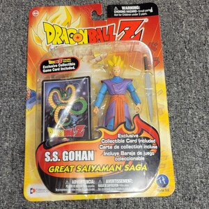 May include: A plastic package containing a Dragon Ball Z action figure of S.S. Gohan in his Great Saiyaman Saga form. The figure is holding a sword and is wearing a blue and purple outfit. The package includes an exclusive collectible game card.