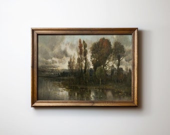 May include: A framed landscape painting depicting a lake with trees and a cloudy sky. The painting is in a brown wooden frame.