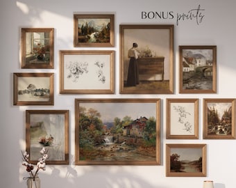 May include: A collection of framed prints with various landscapes, still life, and abstract designs. The prints are arranged on a white wall with a wooden shelf below. The shelf is decorated with a vase of cotton flowers, a pair of glasses, and a book.