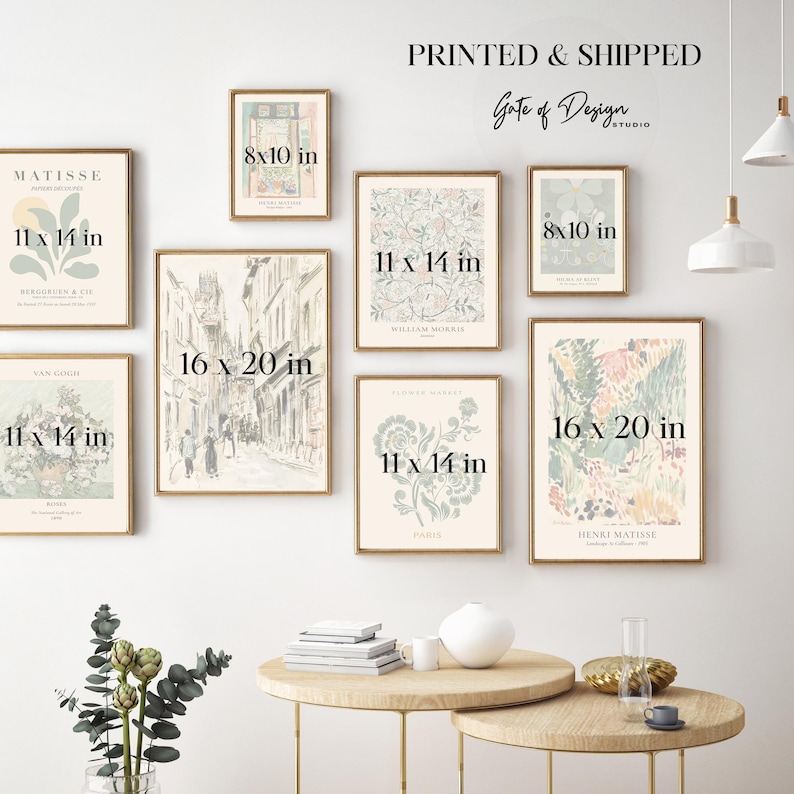 May include: A gallery wall arrangement of eight framed art prints in various sizes, including 8x10, 11x14, and 16x20 inches. The prints feature botanical, floral, and architectural illustrations in muted pastel tones, displayed on a plain wall.