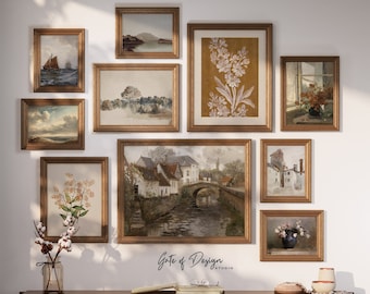 May include: A gallery wall with nine framed prints, featuring various landscapes, floral designs, and architectural scenes. The frames are all gold and have a vintage aesthetic. The wall is white and the frames are arranged in a symmetrical pattern.