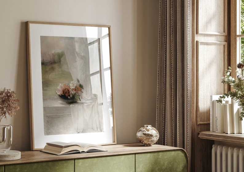 May include: A framed painting of a still life with a bouquet of flowers in a vase on a table with a white cloth. The painting is in a light wood frame and is hanging on a wall.