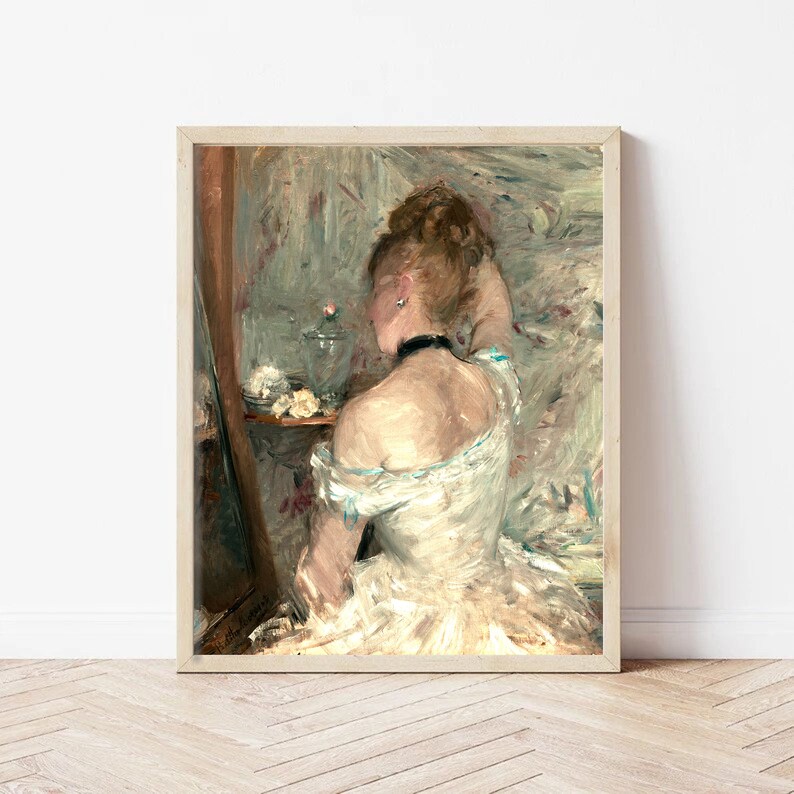 May include: A painting of a woman in a white dress, sitting in front of a mirror. She is looking at her reflection and has her hand on her hair. The background is a light blue and green.