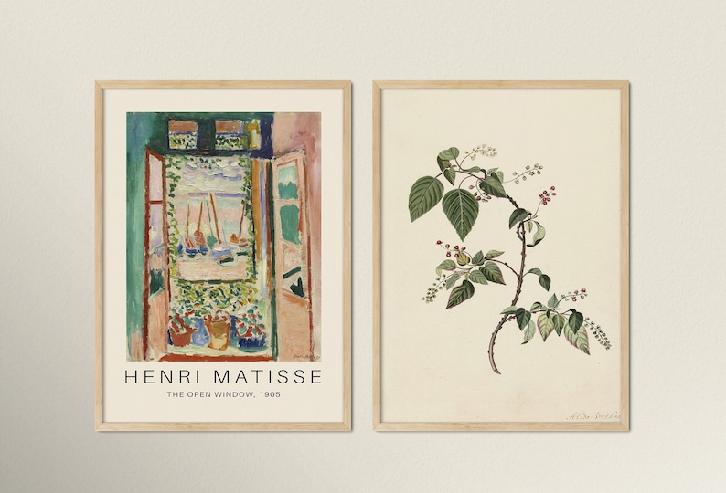 May include: Two framed art prints. The left print is a painting of a window with a view of boats and water. The text below the painting reads "Henri Matisse, The Open Window, 1905". The right print is a botanical illustration of a green plant with red berries.