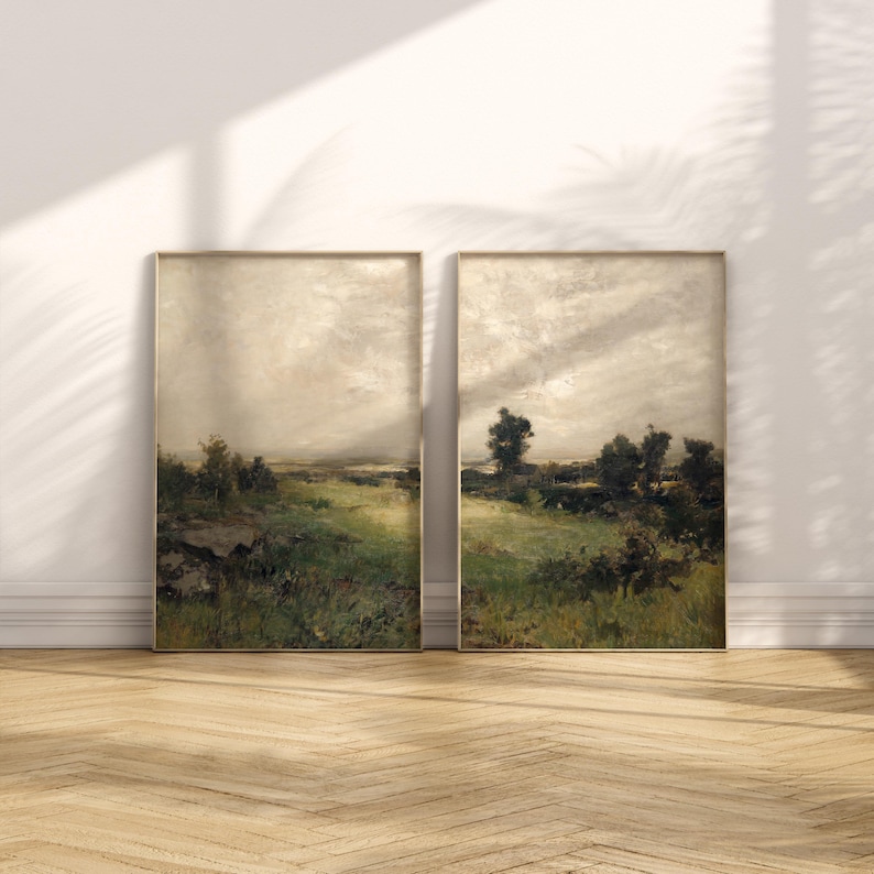 May include: Two framed landscape paintings with a muted color palette depicting a field with trees and a cloudy sky.