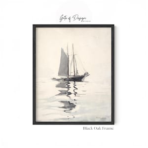 May include: A framed wall art print featuring a watercolor painting of a sailboat on calm water. The artwork displays a grey sailboat with a reflection on the surface, set within a black oak frame. The text Gate of Design Studio is visible.