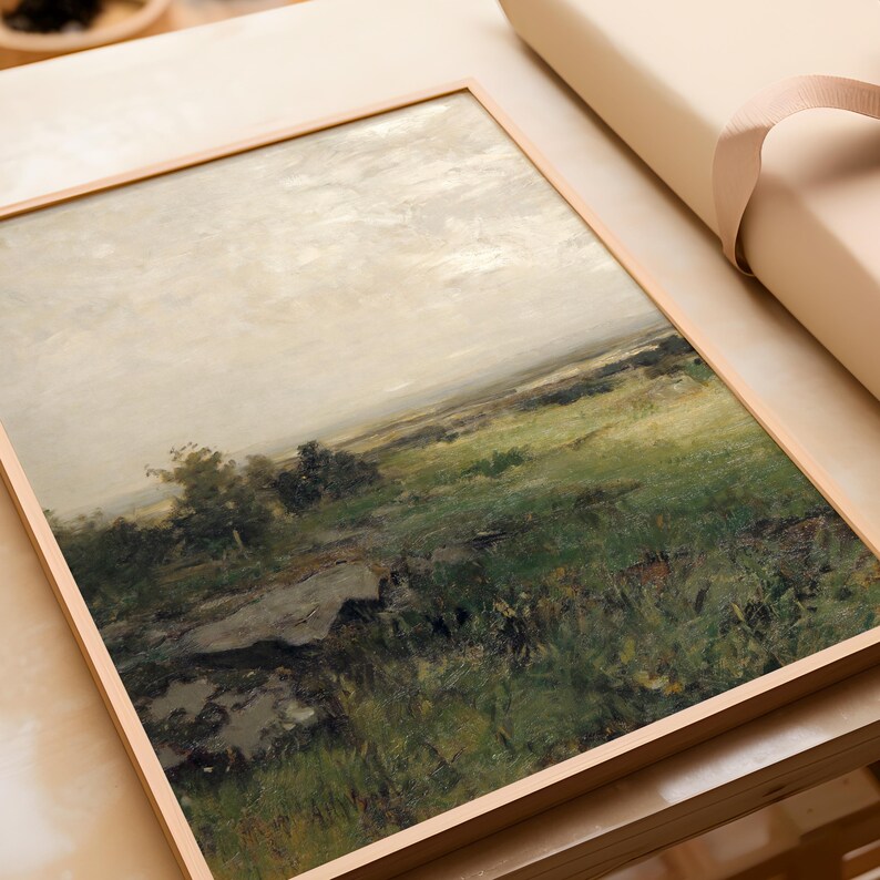 May include: A framed painting of a landscape with a field of green grass and a cloudy sky. The painting is in a wooden frame.