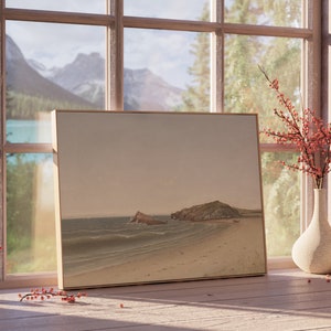 May include: A framed landscape painting of a beach with two rocky islands in the distance. The painting is on a wooden table next to a vase with red berries and a small ceramic vase.