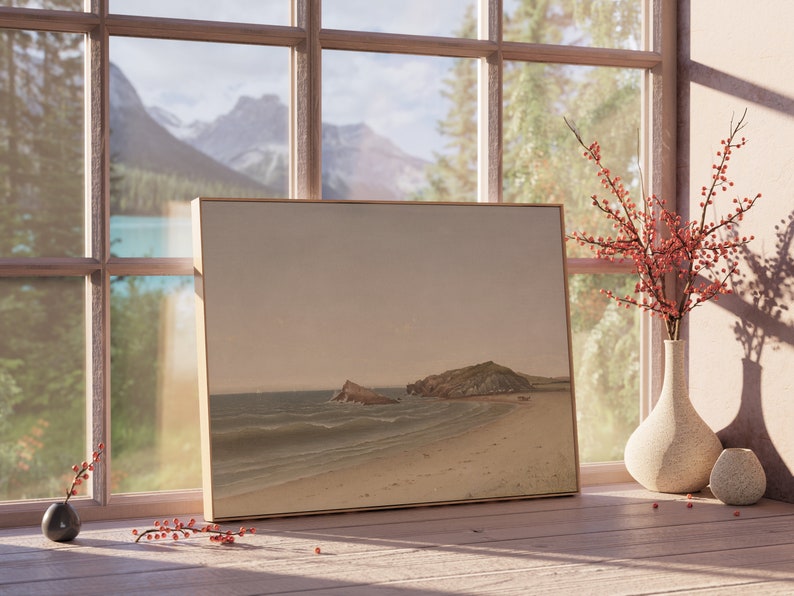May include: A framed landscape painting of a beach with two rocky islands in the distance. The painting is on a wooden table next to a vase with red berries and a small ceramic vase.