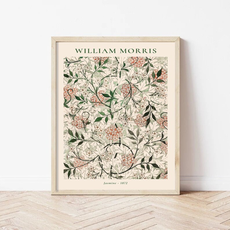 May include: A framed print of a floral pattern by William Morris, titled "Jasmine - 1872". The design features a repeating pattern of white flowers, green leaves, and orange-red berries on a cream background.