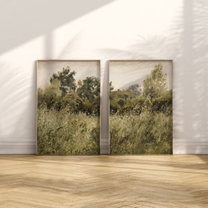 May include: Two framed landscape paintings depicting a field of tall grass and trees in the distance. The paintings are in a muted green and brown color palette.
