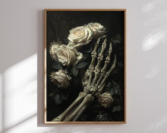 May include: A framed art print featuring a skeletal hand holding a bouquet of white roses. The artwork has a dark, moody aesthetic with a focus on the contrast between the delicate flowers and the bony hand. The roses are in full bloom, with detailed petals.