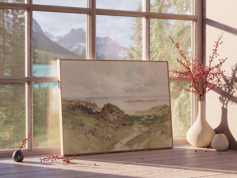 May include: A framed watercolor painting of a landscape with a path leading to a body of water. The painting is on a wooden table with a vase of red berries and a small ceramic vase.
