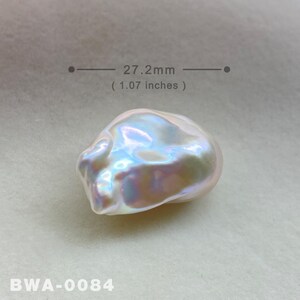 May include: A large, iridescent white baroque pearl measuring 27.2 mm (1.07 inches) in diameter. The pearl has an irregular shape with a smooth, glossy surface.