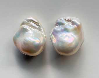 May include: Two large, irregular, white baroque pearls with iridescent sheen.  BWWA-0028