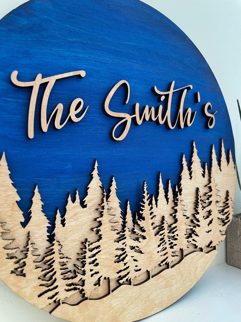 family-name-sign-round-wooden-treeline-name-signage-nature-landscape