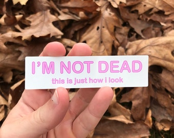 May include: White sticker with pink text that reads "I'm not dead, this is just how I look".