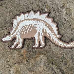 Stegosaurus Dinosaur Iron Patch: Glow in the Dark Bones (7.1” x 3.7”)