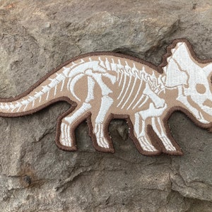 Triceratops Dinosaur Iron Patch: Glow in the Dark Bones (7.5” x 3.3”)