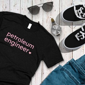 May include: Black t-shirt with the text "petroleum engineer" in pink lettering with a pink heart.