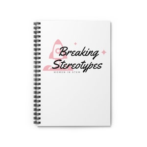May include: A white spiral notebook with a pink rocket ship and the text "Breaking Stereotypes" in black. The text "Women in STEM" is also in black below the main text.