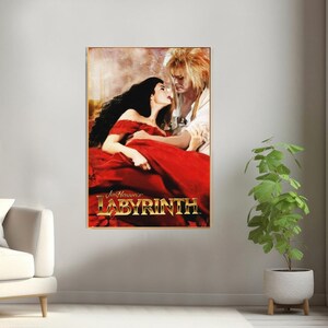May include: A movie poster for Jim Henson's Labyrinth, featuring a man and a woman in a romantic embrace. The poster has a gold frame and the title "Labyrinth" is in gold lettering.