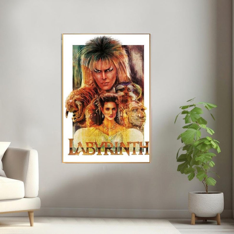May include: A vintage-style poster for the movie Labyrinth, featuring a colorful illustration of Jareth the Goblin King and Sarah Williams. The poster has a gold frame and the title "Labyrinth" is printed in bold, gold letters.