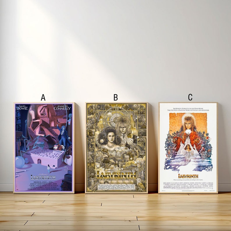 May include: Three movie posters for the film Labyrinth, featuring David Bowie as Jareth the Goblin King. The posters are in different styles, with one featuring a pink and purple color scheme, one featuring a gold and black color scheme, and one featuring a more traditional movie poster design.