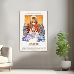 May include: A vintage movie poster for the film Labyrinth, featuring a colorful illustration of David Bowie as the Goblin King, surrounded by fantastical creatures and a maze. The text on the poster reads "Jim Henson, George Lucas and David Bowie take you into a dazzling world of fantasy and adventure."