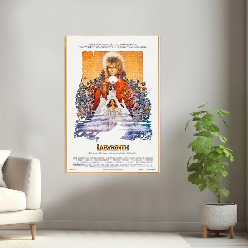 May include: A vintage movie poster for the film Labyrinth, featuring a colorful illustration of David Bowie as the Goblin King, surrounded by fantastical creatures and a maze. The text on the poster reads "Jim Henson, George Lucas and David Bowie take you into a dazzling world of fantasy and adventure."