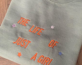 Album Inspired Embroidered Green Crewneck Sweatshirt with Album Inspired Quote - &#39;The Life Of Just A Girl&#39; and Stars