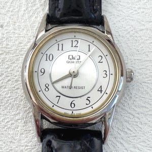Vintage Q&Q Quartz Wristwatch Silver Tone White Dial Black Strap Water Resistant Japan Movement