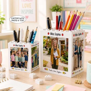 May include: Two white square pencil holders with building block textures on top, personalized with the name Miss Sophia and custom photos. The holders feature the text Teach, Love, Inspire and are filled with various colored pens and pencils.