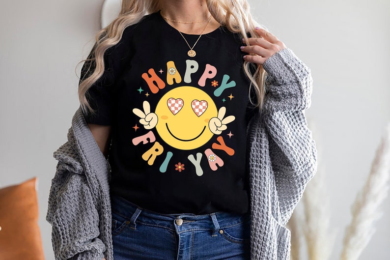 May include: A black t-shirt with a colorful graphic of a smiley face with heart eyes and the text "Happy Fri-yay".