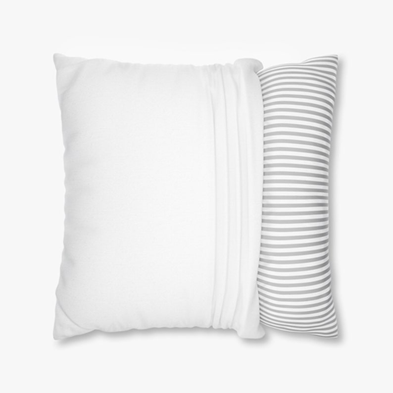May include: Two pillows. A large, square white pillow with a pleated edge is next to a long, cylindrical pillow with gray and white horizontal stripes. The pillows are on a white background.