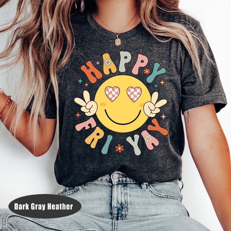 May include: Dark gray heather t-shirt with a colorful graphic of a smiley face with peace signs and the text "Happy Fri-yay".